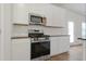 Bright kitchen features stainless steel appliances, white cabinets, and granite countertops at 342 Orwell Drive Lot 95, Social Circle, GA 30025