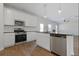 Bright kitchen features stainless steel appliances, white cabinetry, and a center island with a dark countertop at 342 Orwell Drive Lot 95, Social Circle, GA 30025