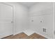 Clean laundry room offers functionality with a wire shelf, utility connections, and easy access with a white door at 342 Orwell Drive Lot 95, Social Circle, GA 30025