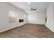 Spacious, light-filled living room with wood-look floors, a modern fireplace, and staircase access, perfect for relaxation at 342 Orwell Drive Lot 95, Social Circle, GA 30025