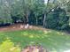Expansive backyard with a charming firepit area featuring Adirondack chairs, all surrounded by lush greenery at 5085 Johns Creek Ct, Johns Creek, GA 30022