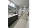 Modern bathroom with a glass-enclosed shower, gray cabinets, and tile floors at 5085 Johns Creek Ct, Johns Creek, GA 30022