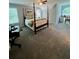 Bright bedroom with a four-poster bed, desk, and a picturesque window view at 5085 Johns Creek Ct, Johns Creek, GA 30022
