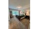 Comfortable bedroom with a four-poster bed, soft carpet, and a window with a view at 5085 Johns Creek Ct, Johns Creek, GA 30022