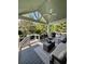 Stylish covered deck with outdoor seating, a ceiling fan, and views of the lush backyard landscape at 5085 Johns Creek Ct, Johns Creek, GA 30022