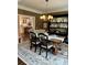 Traditional dining room with dark wood table, china cabinet, and an area rug at 5085 Johns Creek Ct, Johns Creek, GA 30022