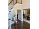 Elegant foyer with hardwood floors, a curved staircase, and a view into the dining room, offering a warm welcome at 5085 Johns Creek Ct, Johns Creek, GA 30022