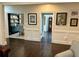 Hallway with dark stained hardwood floors and wainscotting at 5085 Johns Creek Ct, Johns Creek, GA 30022