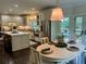 Modern kitchen with stainless steel appliances, a center island, and access to outdoor living spaces at 5085 Johns Creek Ct, Johns Creek, GA 30022