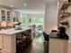 Spacious kitchen with a center island, stainless steel appliances, and an adjacent breakfast nook at 5085 Johns Creek Ct, Johns Creek, GA 30022