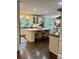 Bright, open kitchen with white cabinets, a large island, and modern appliances at 5085 Johns Creek Ct, Johns Creek, GA 30022