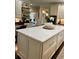 Elegant kitchen island featuring white countertop and a variety of storage solutions at 5085 Johns Creek Ct, Johns Creek, GA 30022