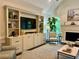 Spacious living room with built-in media center and ample natural light at 5085 Johns Creek Ct, Johns Creek, GA 30022