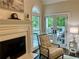 Cozy sitting area by fireplace with doors leading to an outdoor patio at 5085 Johns Creek Ct, Johns Creek, GA 30022
