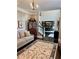 Comfortable living room with neutral tones, stylish decor, and an open view of the staircase and dining area at 5085 Johns Creek Ct, Johns Creek, GA 30022