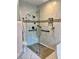 Modern walk-in shower with rainfall showerhead, bench, and decorative tile at 5085 Johns Creek Ct, Johns Creek, GA 30022