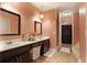 Double vanity bathroom featuring dark wood cabinets, white countertops and a spacious layout at , Stockbridge, GA 30281
