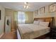 Cozy bedroom featuring a wooden headboard, ceiling fan, and natural lighting at , Stockbridge, GA 30281