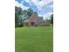 Charming brick home with a well-manicured lawn and mature trees in a peaceful setting at , Stockbridge, GA 30281