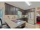 Well-lit kitchen featuring granite countertops, dark cabinets, and stainless steel appliances at , Stockbridge, GA 30281