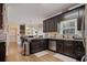 Cozy kitchen with dark wood cabinetry, stainless steel appliances, and granite countertops at , Stockbridge, GA 30281