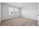 Bright bedroom with dual windows and carpet flooring, creating a comfortable atmosphere at 358 Orwell Dr, Social Circle, GA 30025
