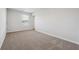 Cozy bedroom with plush carpeting, a window offering natural light, and neutral wall colors at 358 Orwell Dr, Social Circle, GA 30025