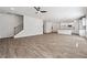 Expansive living room featuring hardwood floors and an open layout to the modern kitchen at 358 Orwell Dr, Social Circle, GA 30025