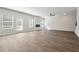 Spacious living room with hardwood floors, modern fireplace, and abundant natural light at 358 Orwell Dr, Social Circle, GA 30025