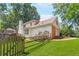 Backyard view featuring a well-maintained lawn, deck, trees and partial view of brick garage at 3794 Brown Owl Ct, Marietta, GA 30062