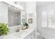 Bright bathroom features a large vanity, framed mirror and a decorative window with shutters at 3794 Brown Owl Ct, Marietta, GA 30062