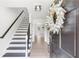 Inviting foyer with a staircase and light wood flooring, showcasing a modern aesthetic at 3794 Brown Owl Ct, Marietta, GA 30062