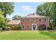 Charming brick home featuring a manicured lawn and traditional architectural details at 3794 Brown Owl Ct, Marietta, GA 30062