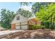 Side view of home showcasing a two-car garage and brick exterior at 3794 Brown Owl Ct, Marietta, GA 30062
