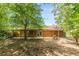 Back exterior of wood-sided home with covered back porch, perfect for enjoying the outdoors at 800 Greenwood Se Trl, Conyers, GA 30094