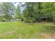 Expansive backyard featuring mature trees and lush greenery, offering privacy and a serene outdoor space at 800 Greenwood Se Trl, Conyers, GA 30094
