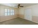 Bedroom with neutral carpet, closet, ceiling fan and shuttered windows at 800 Greenwood Se Trl, Conyers, GA 30094