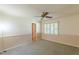 Bedroom with neutral colored carpet, ceiling fan, two toned wall paint and shuttered window at 800 Greenwood Se Trl, Conyers, GA 30094