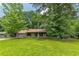 Charming single-story home with wood siding, stone accents, a blue front door, and a lush green lawn at 800 Greenwood Se Trl, Conyers, GA 30094