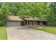 Charming exterior of a well-maintained home with a long driveway and a lush green lawn at 800 Greenwood Se Trl, Conyers, GA 30094