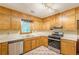 Kitchen featuring stainless steel appliances, double sink, and many upper and lower wooden cabinets at 800 Greenwood Se Trl, Conyers, GA 30094