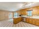View of kitchen featuring ample wooden cabinets, stainless steel appliances and checkered floors at 800 Greenwood Se Trl, Conyers, GA 30094