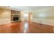 Bright living room showcasing a brick fireplace, hardwood floors, and neutral-colored walls at 800 Greenwood Se Trl, Conyers, GA 30094