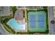 Aerial view of community pool, tennis courts, and clubhouse surrounded by lush landscaping and mature trees at 2626 Sardis Chase Ct, Buford, GA 30519