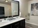 Bathroom featuring a double vanity, bathtub, and a glass shower stall at 2626 Sardis Chase Ct, Buford, GA 30519