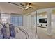 Primary bedroom featuring a four-poster bed, decorative pillars, and television at 2626 Sardis Chase Ct, Buford, GA 30519