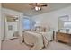 Cozy bedroom featuring soft carpet, a decorative mirror, and a comfortable queen-sized bed at 2626 Sardis Chase Ct, Buford, GA 30519