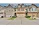 Townhome exteriors with coordinated design elements and convenient parking at 2626 Sardis Chase Ct, Buford, GA 30519