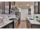 Well-equipped kitchen with dark cabinetry, stainless steel appliances, and ample counter space at 2626 Sardis Chase Ct, Buford, GA 30519