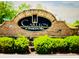 Stone community entrance sign that reads 'Carlton at Hamilton Mill' surrounded by landscaped bushes and trees at 2626 Sardis Chase Ct, Buford, GA 30519